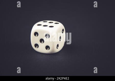 White dice on black table background Stock Photo