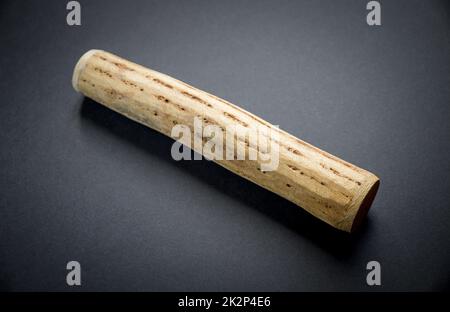 Traditional rain stick made of cactus wood isolated on black Stock Photo