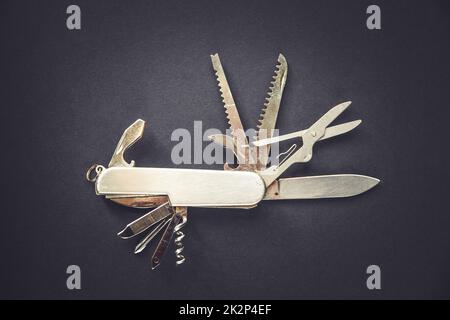 Metallic swiss knife isolated on black Stock Photo