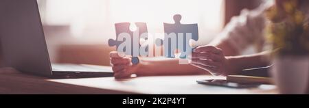 Woman holding pieces of puzzle in the office Stock Photo