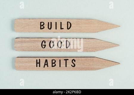 The words build good habits are standing on arrows, change lifestyle, healthy and positive attidude, motivation concept Stock Photo