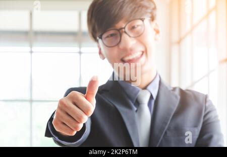 Happy businessman giving thumbs up. Stock Photo