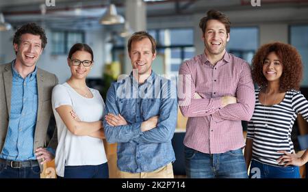 Achieving our corporate goals together. Diverse group of professionals standing confidently in a row. Stock Photo