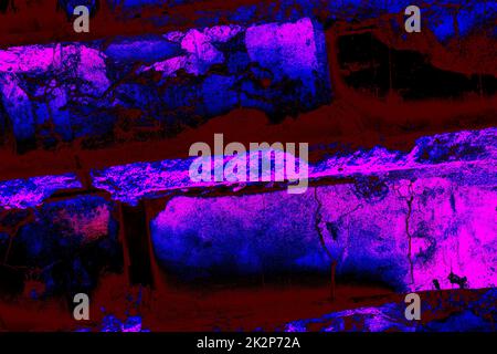 Neon red destroyed brick wall with magenta pink shine. Stock Photo