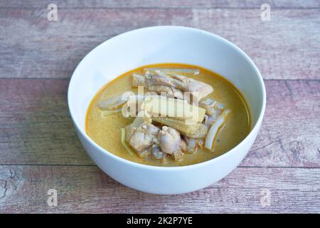 spicy boiled slice banana blossom with chicken in curry and coconut milk soup on bowl Stock Photo