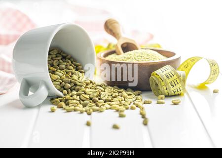 Unroasted green coffee beans on white table. Stock Photo