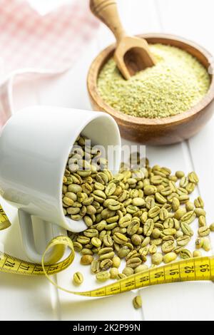 Unroasted green coffee beans on white table. Stock Photo