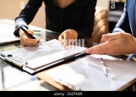 Two Businesspeople Working On Contract Paper Stock Photo