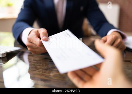 Hand Giving Payroll Compensation Paycheck Stock Photo