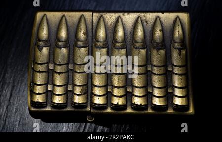 Old matches decorated with bullets Stock Photo