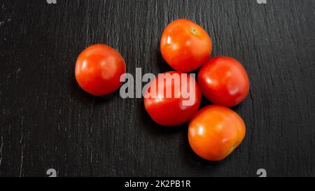 freshness tomatoes black table Stock Photo