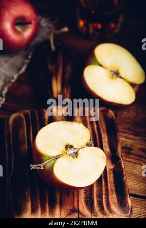 Halved Red Apple on Cutting Board Stock Photo