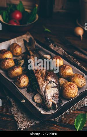 Fish Stuffed with Sorrel and Baked with Potatoes Stock Photo