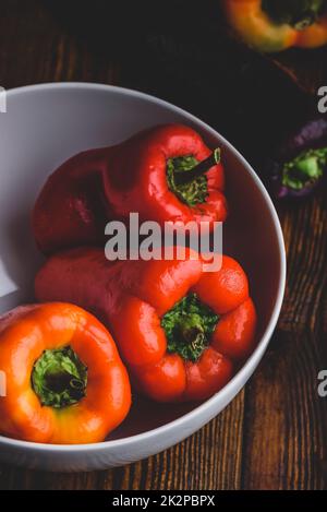 Fresh bell peppers in bowl Stock Photo