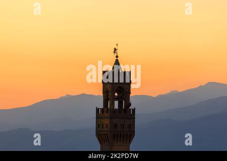 Sunset view at Palazzo vecchio tower in Florence with the mountains in background Stock Photo