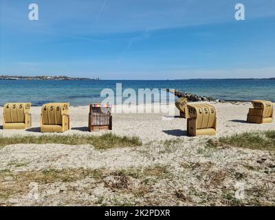 Beach chairs on a sunny summer day on the beach at the Baltic Sea. Stock Photo