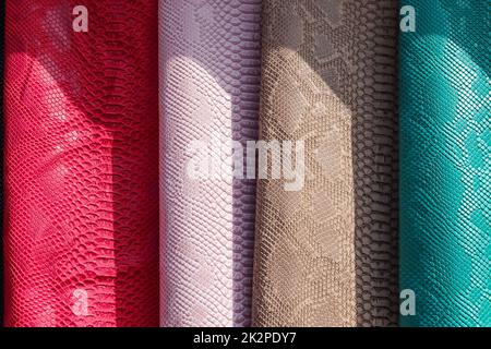 Samples of cloth and fabrics in different colors found at a fabrics market. Stock Photo
