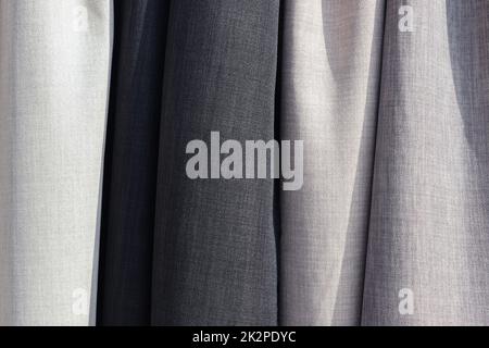 Samples of cloth and fabrics in different colors found at a fabrics market. Stock Photo