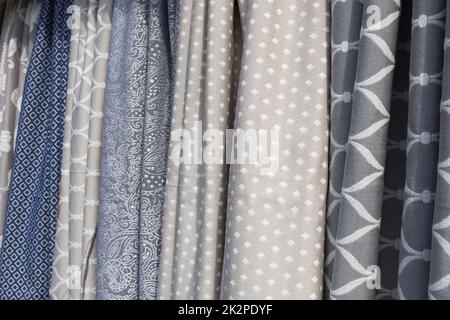 Samples of cloth and fabrics in different colors found at a fabrics market. Stock Photo