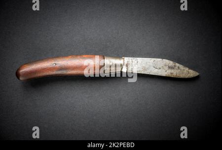 Traditional wooden pocket knife on black background Stock Photo