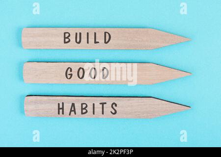 The words build good habits are standing on arrows, change lifestyle, healthy and positive attidude, motivation concept Stock Photo