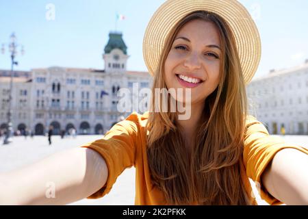 Tourism in Europe. Self portrait of smiling young tourist woman visiting Trieste, Italy. Stock Photo