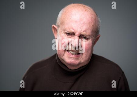 Senior man lonely at home, anxious/afraid to go out - self isolation/ quarantine due to COVID-19/ Coronavirus social distancing/prevention concept Stock Photo