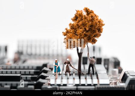 Farmers planting a tree on circuit board. Electronic waste recycling concept Stock Photo