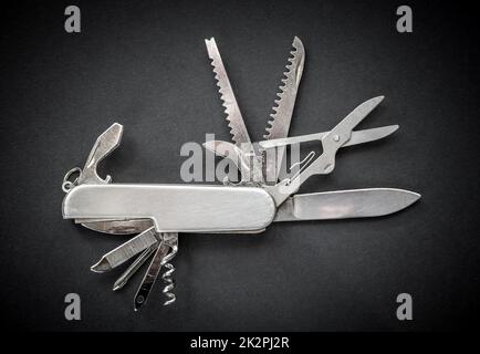 Metallic swiss knife isolated on black Stock Photo