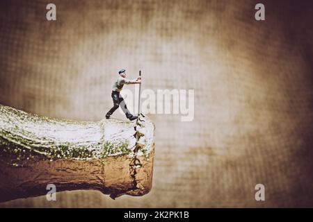 Miniature worker opening a beer bottle. Color tone tuned photo Stock Photo