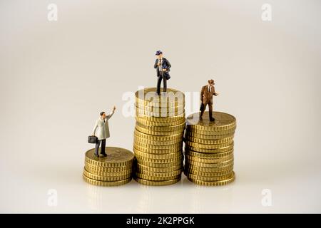 Businessman on the top of coins stack Stock Photo