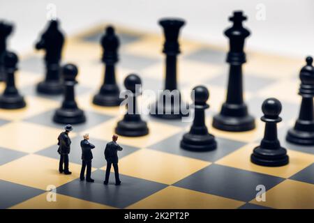 Businessmen on a chessboard. Business strategy concept Stock Photo