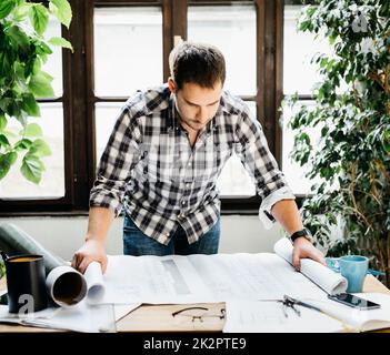 Man working on architectural project Stock Photo