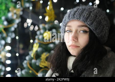 young beautiful happy Face of smiling girl posing. Christmas on background. Happy New Year with lights Stock Photo