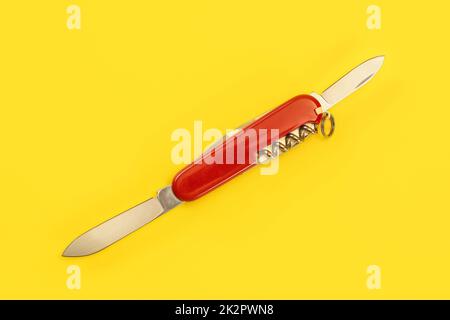 Tabletop view, red pocket knife, with both blades opened, laying on yellow board. Stock Photo