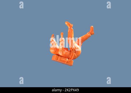 Falling orange astronaut. 3D illustration Stock Photo