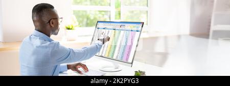 Analyst Employee Working With Spreadsheet Stock Photo