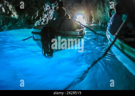 Canoes Inside turquoise grotto, Capri blue cave, Italy Stock Photo