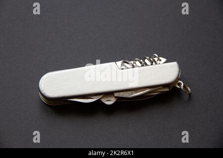 Metallic swiss knife isolated on black Stock Photo
