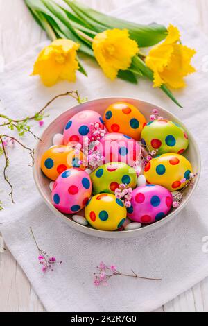 Easter eggs and tulips on grey background Stock Photo