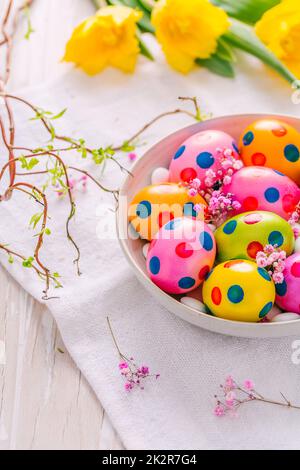 Easter eggs and tulips on grey background Stock Photo