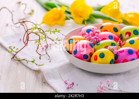 Easter eggs and tulips on grey background Stock Photo