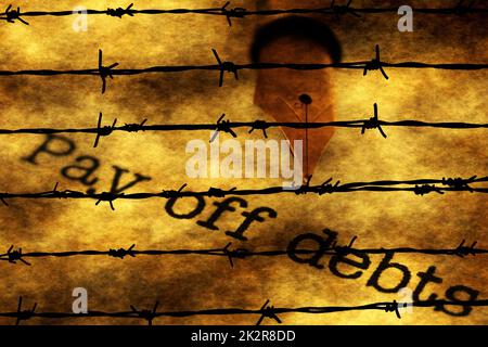 Pay of debts text against barbwire Stock Photo