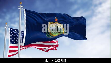 The Vermont state flag waving along with the national flag of the United States of America Stock Photo