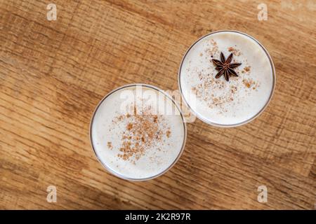 Eggnog with cinnamon and nutmeg for Christmas and winter holidays. Homemade  eggnog in glasses on wooden table surface, shallow depth of the field, cop  Stock Photo - Alamy