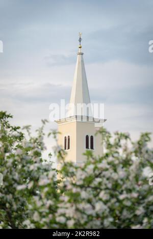 white belltower of a church in Burgenland Stock Photo