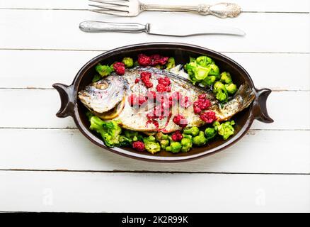 Tasty gilthead fish in berry sauce. Stock Photo