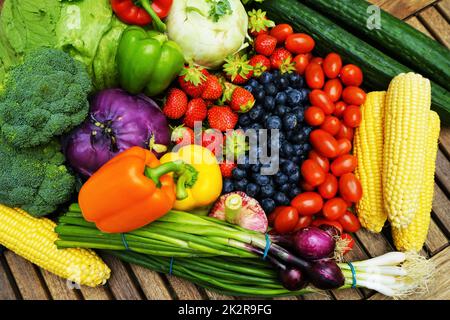 Fresh healthy fruits and vegetables on a wooden table Stock Photo