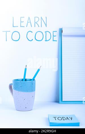 Hand writing sign Learn To Code. Concept meaning Learn to write Software Be a Computer Programmer Coder Stock Photo