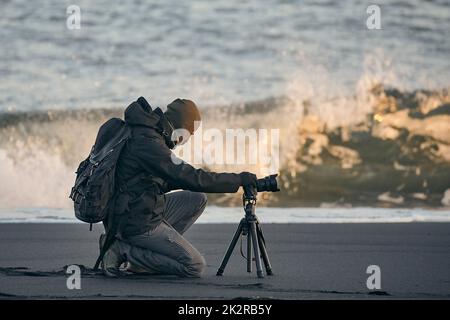 Photographer with tripod on an Icelandic beach Stock Photo